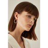Profile view of model wearing the Oroton Bamboo Medium Oval Hoops in Gold and Brass Base With 18CT Gold Plating for Women