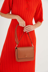 Profile view of model wearing the Oroton Harriet Crossbody in Cognac and Saffiano Leather With Smooth Leather Trim for Women