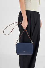 Profile view of model wearing the Oroton Harriet Crossbody in Indigo and Saffiano Leather With Smooth Leather Trim for Women