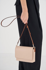 Profile view of model wearing the Oroton Harriet Crossbody in Praline and Saffiano Leather With Smooth Leather Trim for Women