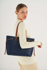 Profile view of model wearing the Oroton Harriet Medium Tote in Indigo and Saffiano Leather With Smooth Leather Trim for Women