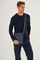 Profile view of model wearing the Oroton Hugo Messenger Bag in Ink and Saffiano Leather for Men