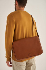 Profile view of model wearing the Oroton Harry Pebble EW Satchel in Cognac and Pebble Leather for Men