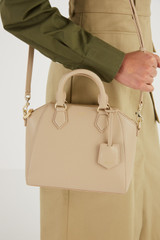 Profile view of model wearing the Oroton Inez Mini Day Bag in Fawn and Saffiano Leather for Women