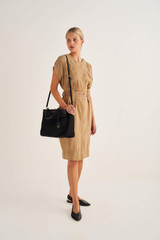 Profile view of model wearing the Oroton Inez Nylon 13" Worker Tote in Black and Nylon/ Shiny Soft Saffiano for Women