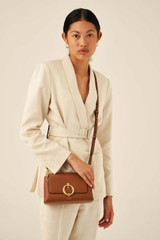 Profile view of model wearing the Oroton Alexa Crossbody in Cognac and Nappa Leather for Women
