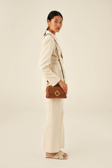 Profile view of model wearing the Oroton Alexa Crossbody in Cognac and Nappa Leather for Women