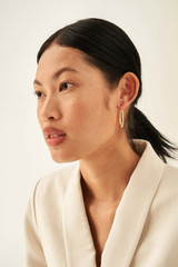 Profile view of model wearing the Oroton Fiona Oblong Hoops in Gold and Brass Base With 18CT Gold Plating for Women