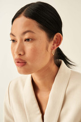 Profile view of model wearing the Oroton Fiona Small Oblong Hoops in Gold and Brass Base With 18CT Gold Plating for Women