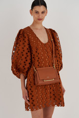 Profile view of model wearing the Oroton Elm Small Day Bag in Brandy and Pebble Leather With Smooth Leather Trim for Women