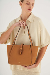 Profile view of model wearing the Oroton Dylan Small Tote in Tan and Pebble Leather for Women