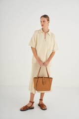 Profile view of model wearing the Oroton Dylan Small Tote in Tan and Pebble Leather for Women