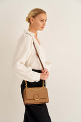 Profile view of model wearing the Oroton Elina Small Satchel in Tan and Pebble Leather for Women