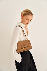 Profile view of model wearing the Oroton Elina Small Satchel in Tan and Pebble Leather for Women