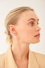 Profile view of model wearing the Oroton Farah Trio Hoop Set in Gold and Brass Base With 18CT Gold Plating for Women