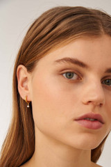 Profile view of model wearing the Oroton Esme Pearl Hoops in Gold/White and 925 Sterling Silver Base With 18CT Gold Plating for Women