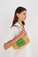 Profile view of model wearing the Oroton Alva Collectable Day Bag in Nat/Grass Green and Smooth Leather and Crocheted Straw for Women