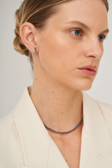 Profile view of model wearing the Oroton Juniper Necklace in Gold/Navy and Brass Base With 18CT Gold Plating for Women