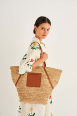 Profile view of model wearing the Oroton Jensen XL Tote in Natural/Brandy and Smooth Leather and Crocheted Straw for Women