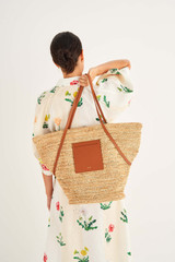 Profile view of model wearing the Oroton Jensen XL Tote in Natural/Brandy and Smooth Leather and Crocheted Straw for Women