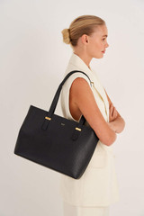 Profile view of model wearing the Oroton Anika 13" Tote & Cover in Black and Pebble leather for Women