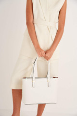 Profile view of model wearing the Oroton Anika 13" Tote & Cover in Cream and Pebble leather for Women