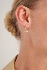 Profile view of model wearing the Oroton Kallie Huggies in Gold and Brass Base With 18CT Gold Plating for Women