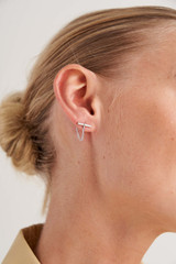 Profile view of model wearing the Oroton Kallie Chain Studs in Silver and Brass Base With Rhodium Plating for Women