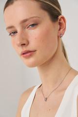 Profile view of model wearing the Oroton Giselle Necklace And Hoops Gift Set in Silver/Clear and  for Women