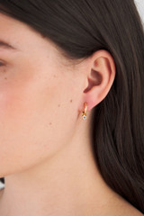 Profile view of model wearing the Oroton Keely Hoops in Gold/Clear and  for Women