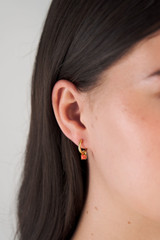 Profile view of model wearing the Oroton Keely Hoops in Gold/Coral and  for Women