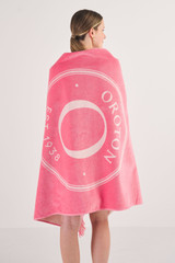Profile view of model wearing the Oroton Kane Towel in Watermelon and 100% Woven Cotton for Women