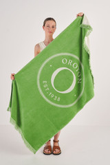 Profile view of model wearing the Oroton Kane Towel in Watercress and 100% Woven Cotton for Women