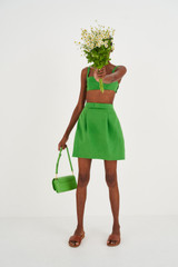 Profile view of model wearing the Oroton Bow Detail Skirt in Garden and 100% Linen for Women