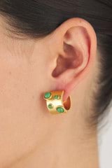 Profile view of model wearing the Oroton Arcadia Huggies in Worn Gold/Green and Brass Base Metal With Precious Metal Plating/Reconstituted Stone for Women