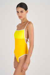 Profile view of model wearing the Oroton Contrast Bind One Piece in Vibrant Yellow and 78% Recycled Nylon/ 22 % Lycra for Women
