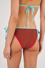 Profile view of model wearing the Oroton Contrast Bind Bikini Bottom in Iced Chocolate and 78% Recycled Nylon/ 22 % Lycra for Women