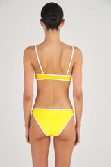 Profile view of model wearing the Oroton Contrast Separate Top in Vibrant Yellow and 78% Recycled Nylon/ 22 % Lycra for Women
