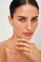 Profile view of model wearing the Oroton Posy Studs in Gold/White and  for Women