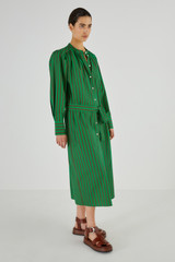 Profile view of model wearing the Oroton Stripe Shirt Dress in Kelly Green and 100% Cotton for Women