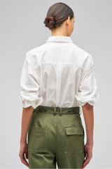 Profile view of model wearing the Oroton Poplin Long Sleeve Shirt in White and 100% cotton for Women