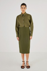 Profile view of model wearing the Oroton Pencil Skirt in Khaki and 61% Cotton, 39% Polyester for Women