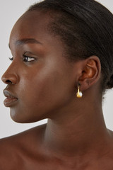 Profile view of model wearing the Oroton Jaclyn Earrings in Worn Gold/White and  for Women