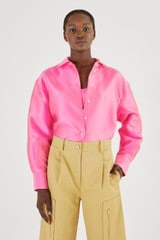 Profile view of model wearing the Oroton Satin Overshirt in Candy Pink and 85% Polyester, 15% Silk for Women