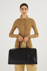 Profile view of model wearing the Oroton Inez Weekender in Black and Saffiano Leather for Women