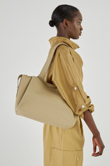Profile view of model wearing the Oroton Alice Carry All in Clay and Pebble Leather for Women