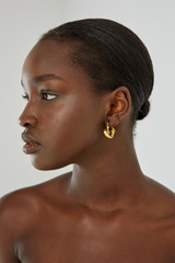Profile view of model wearing the Oroton Mimi Huggies in Worn Gold and  for Women