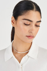 Profile view of model wearing the Oroton Adalyn Pearl Necklace in Silver/White and  for Women