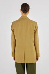 Profile view of model wearing the Oroton Single Breasted Blazer in Tobacco and 58% Viscose 42% Linen for Women