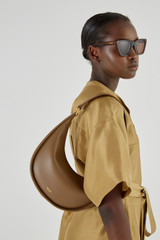 Profile view of model wearing the Oroton Penny Small Shoulder Bag in Willow and Smooth leather for Women